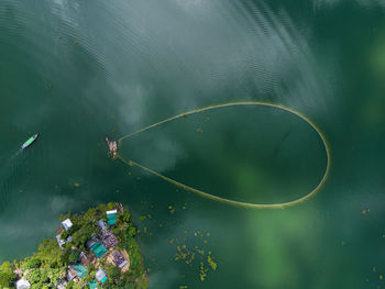 High angle view of people swimming in lake