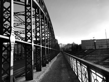 Bridge amidst buildings against sky in city