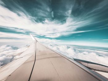 Aerial view of aircraft wing against sky