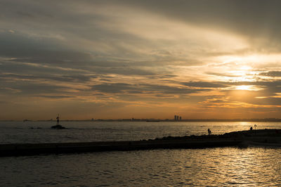 Scenic view of sea against cloudy sky