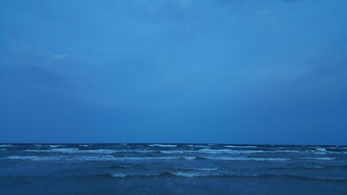 Scenic view of beach against blue sky