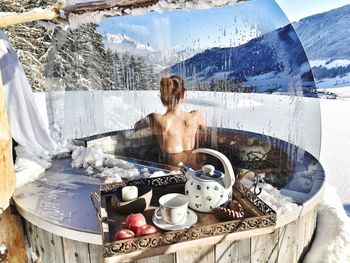 High angle view of shirtless woman sitting against mountains