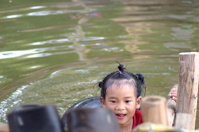 Smiling cute girl swimming in lake