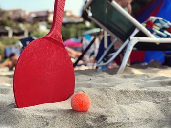 Close-up of ball with matkot racket at beach