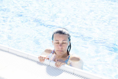 High angle portrait of a woman in swimming pool