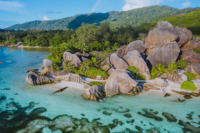 Scenic view of lake and rocks against mountains