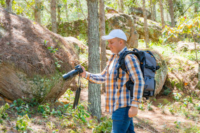 Rear view of man standing in forest