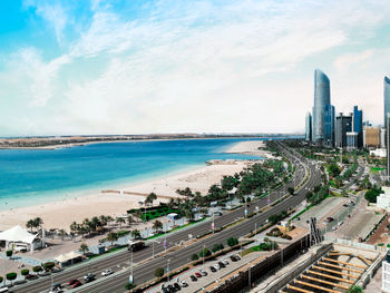 High angle view of buildings by sea against sky