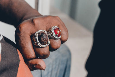 Close-up of man showing rings