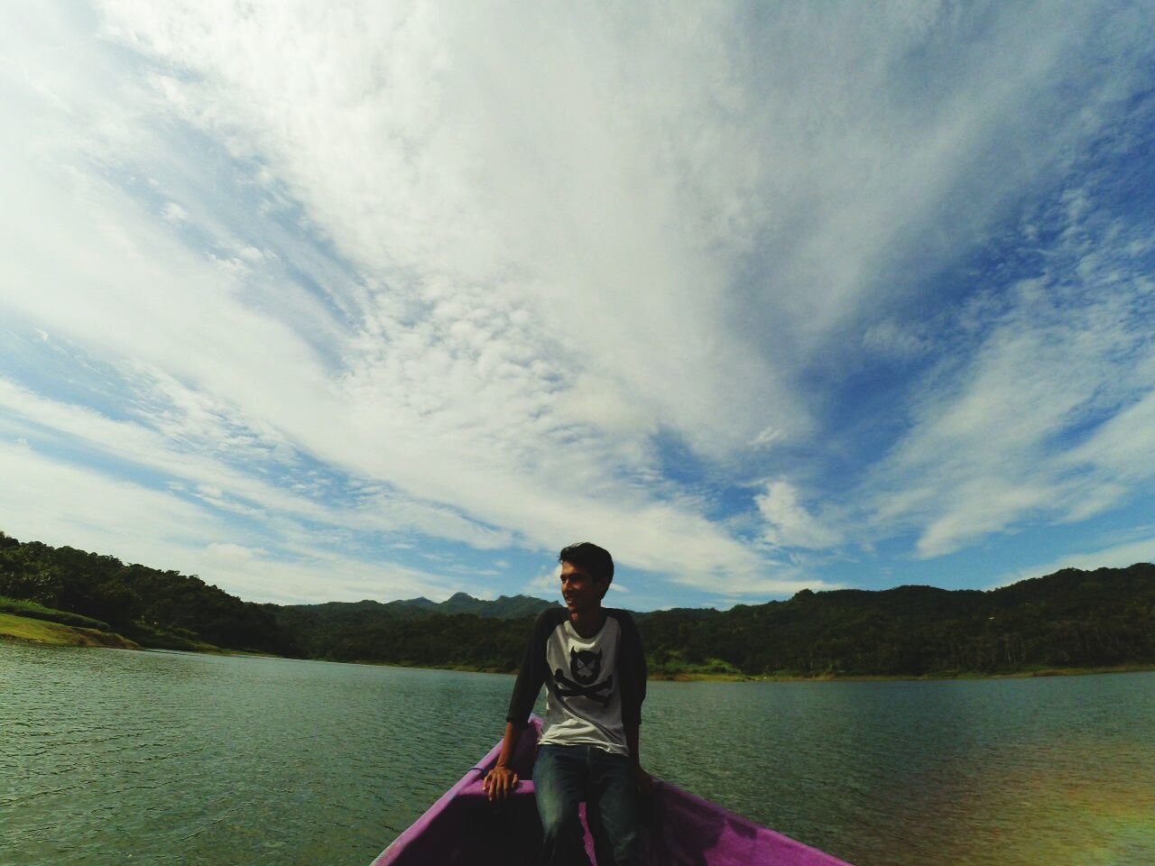 lifestyles, water, leisure activity, sky, casual clothing, standing, young adult, lake, tranquility, cloud - sky, waist up, rear view, three quarter length, tranquil scene, scenics, nature, river, beauty in nature