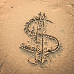 High angle view of dollar sign at beach