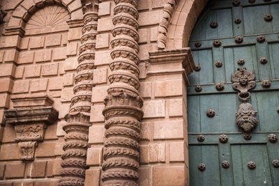 Low angle view of closed door of old building