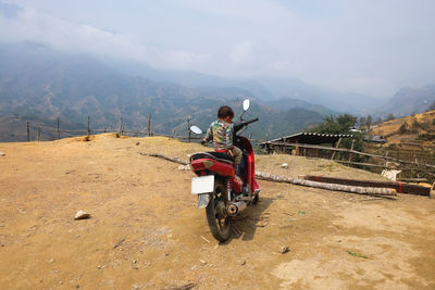 Full length of woman standing on mountain landscape