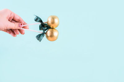 Person holding apple against blue background