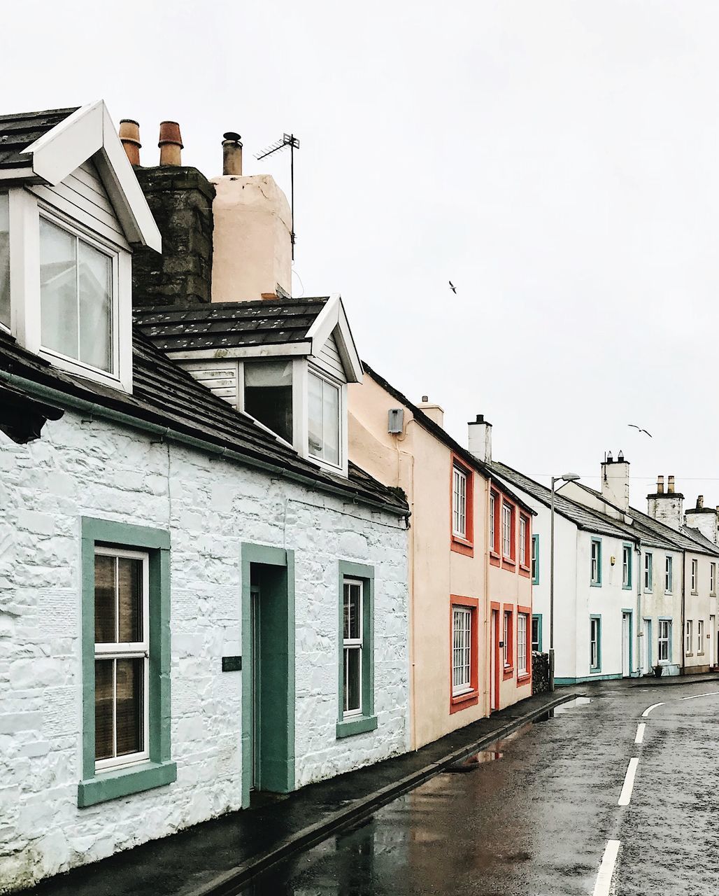 HOUSES BY CITY AGAINST SKY