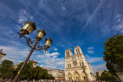 Low angle view of building against cloudy sky