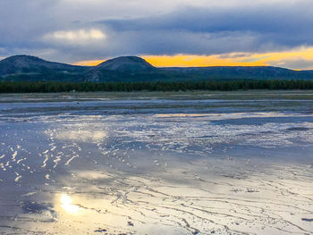 Scenic view of lake against sky during sunset