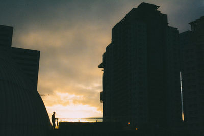 Low angle view of silhouette building against sky during sunset