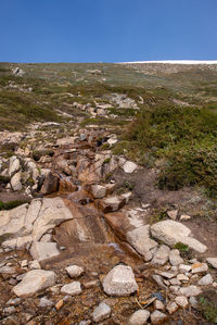 Scenic view of land against clear blue sky