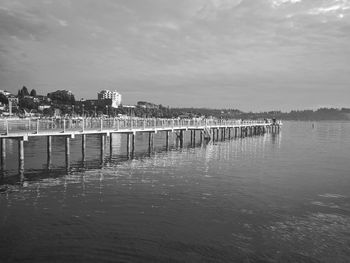 Wooden posts on the sea against sky