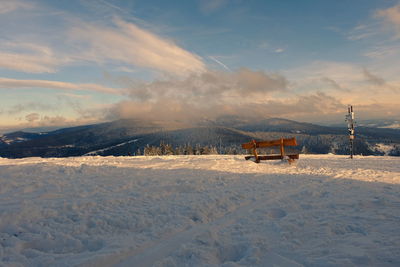 Scenic view of snow covered field against sky