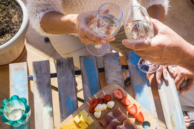 High angle view of people toasting wineglasses