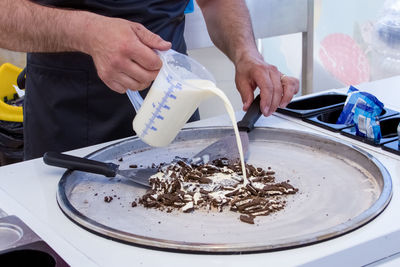 Midsection of man preparing food in workshop