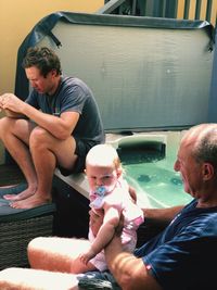 Full length of father and daughter sitting in car