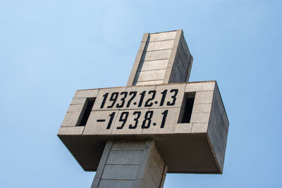 Low angle view of sign against clear blue sky