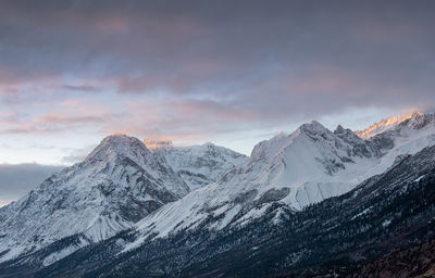 Scenic view of snowcapped mountains against sky during sunrise