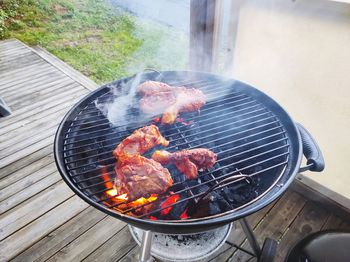 High angle view of meat on barbecue grill