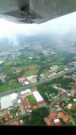 Aerial view of airplane flying over city