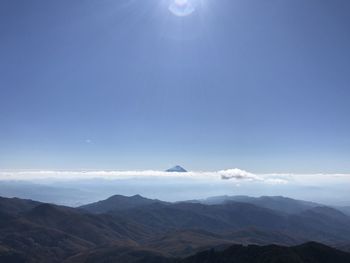 Scenic view of mountains against blue sky