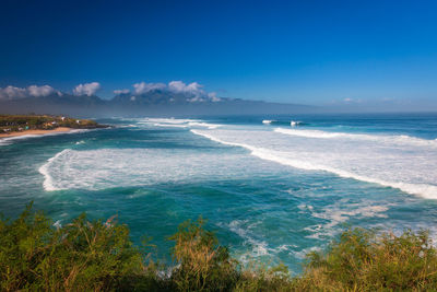 Scenic view of sea against blue sky