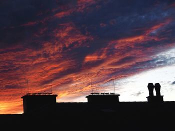 Low angle view of silhouette building against sky during sunset