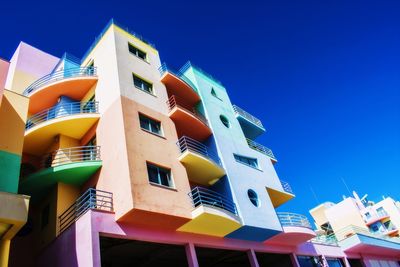 Low angle view of residential buildings against blue sky