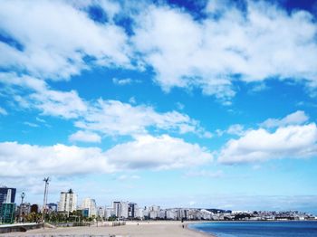 Panoramic view of buildings and sea against sky