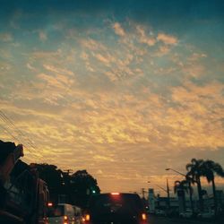 Road against cloudy sky at sunset