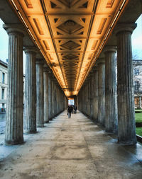 Rear view of people walking on bridge