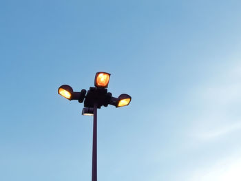 Low angle view of illuminated street light against clear sky