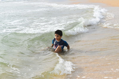 Full length of boy on beach