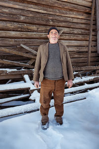 Portrait of man standing in snow