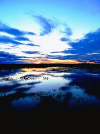 Scenic view of lake against cloudy sky
