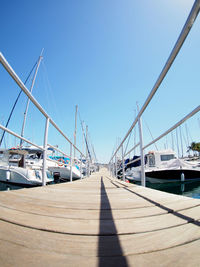 View of suspension bridge against clear blue sky