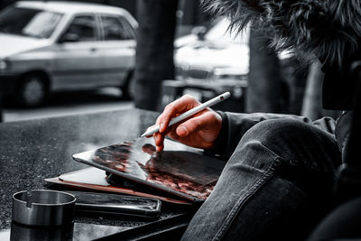 Midsection of man preparing food on street