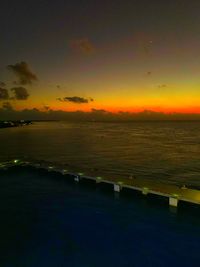 Scenic view of sea against dramatic sky during sunset