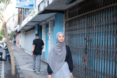 Rear view of woman walking on street