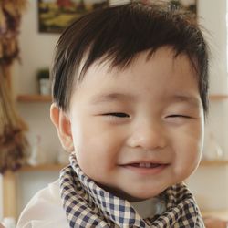 Close-up portrait of cute boy at home