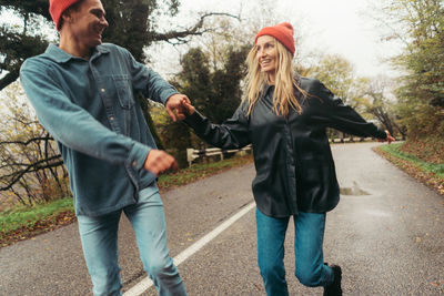 Side view of woman standing on road