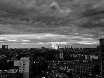 View of cityscape against cloudy sky